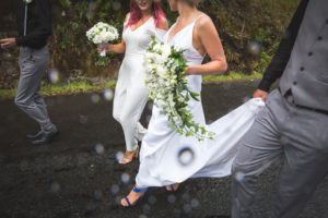 Bridal party walk out in the rain