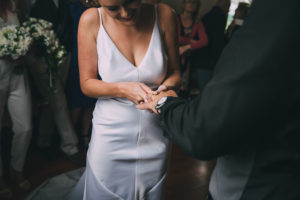 Bride and Groom exchange rings in front of their guests